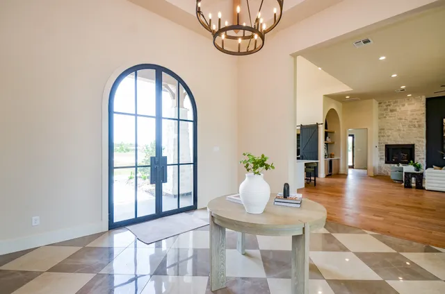 a living room with fireplace furniture and a large window