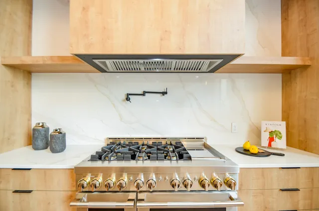 a kitchen with stainless steel appliances a sink and a window