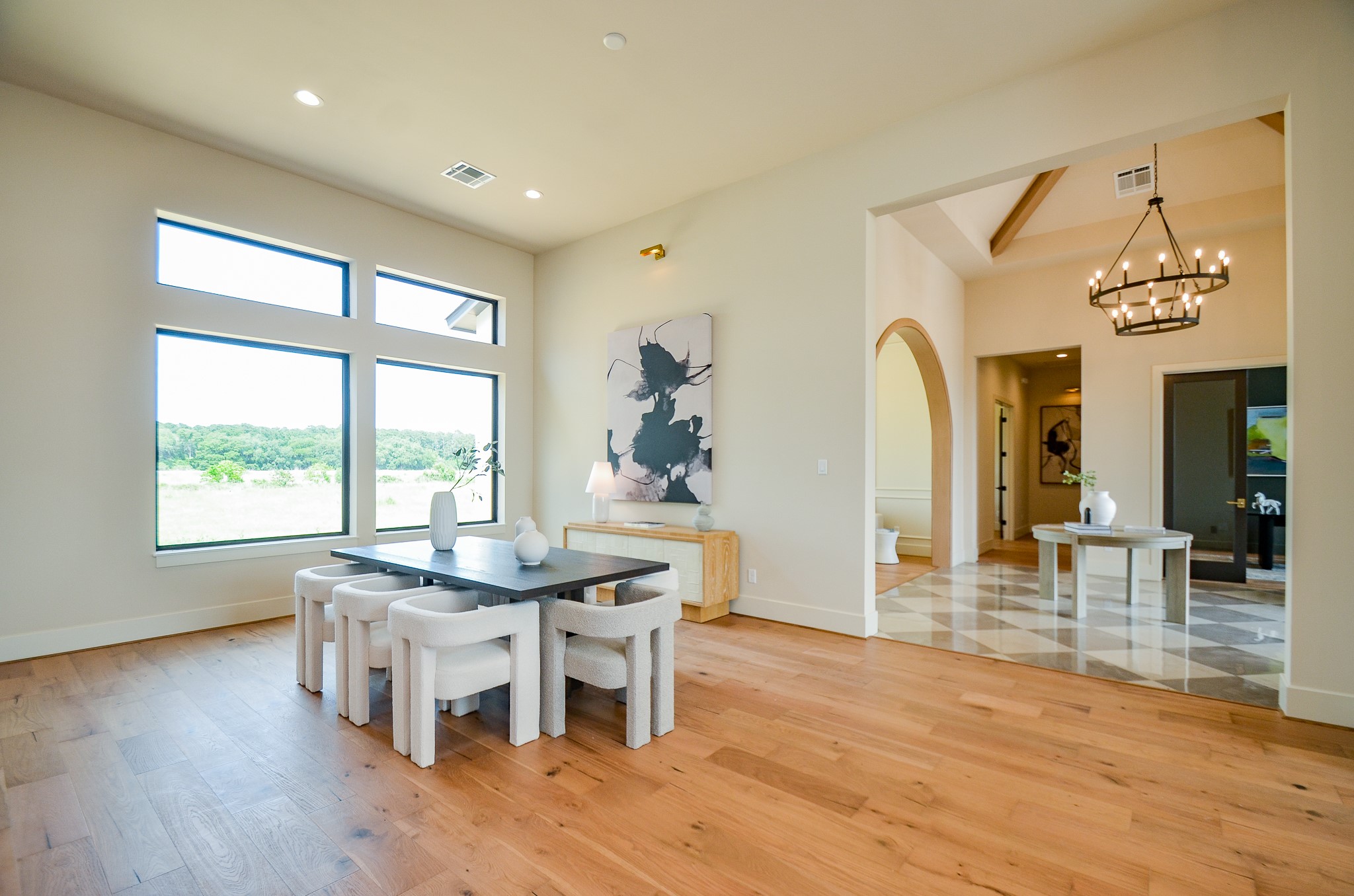 20218 Tealpointe Ridge Lane Tomball, TX 77377 - Photo 36 of 50 a dining room with chandelier and wooden floor