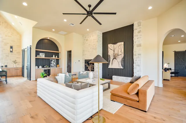 a living room with furniture a fireplace and a flat screen tv