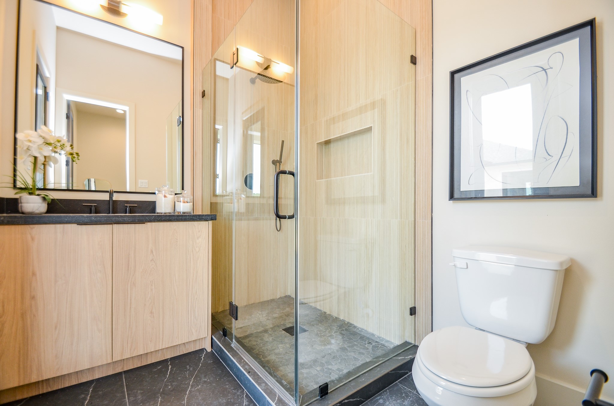 20218 Tealpointe Ridge Lane Tomball, TX 77377 - Photo 10 of 50 a bathroom with a granite countertop sink a toilet a mirror and shower