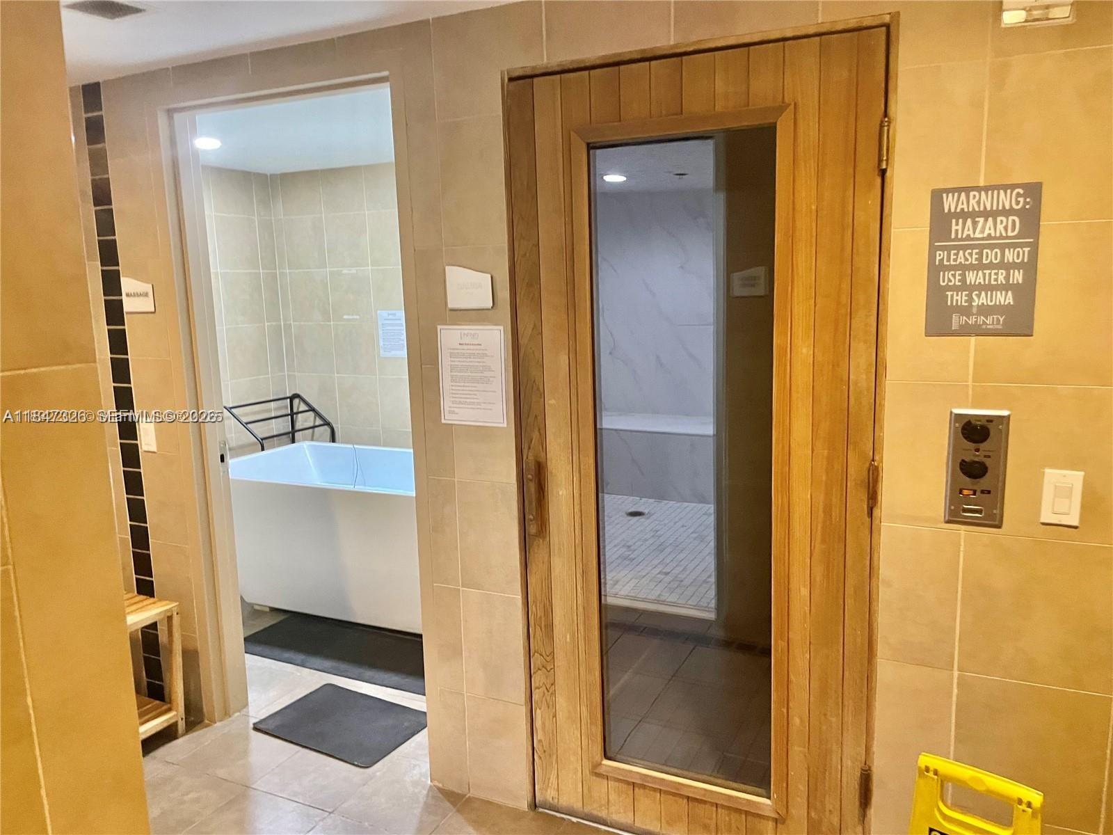 60 Southwest 13th Street, Unit 1605 Miami, FL 33130 - Photo 13 of 25 a bathroom with a tub and a shower