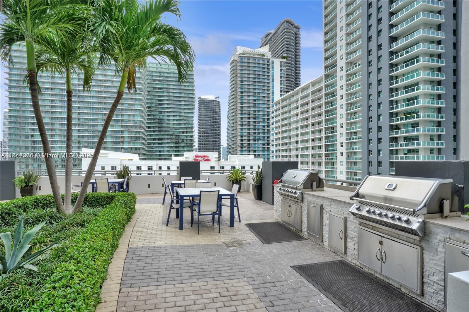 60 Southwest 13th Street, Unit 1605 Miami, FL 33130 - Photo 18 of 28 a view of a patio with table and chairs