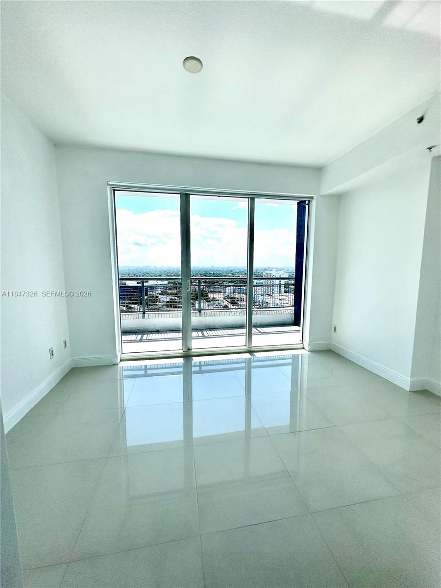 60 Southwest 13th Street, Unit 1605 Miami, FL 33130 - Photo 6 of 25 an empty room with large windows
