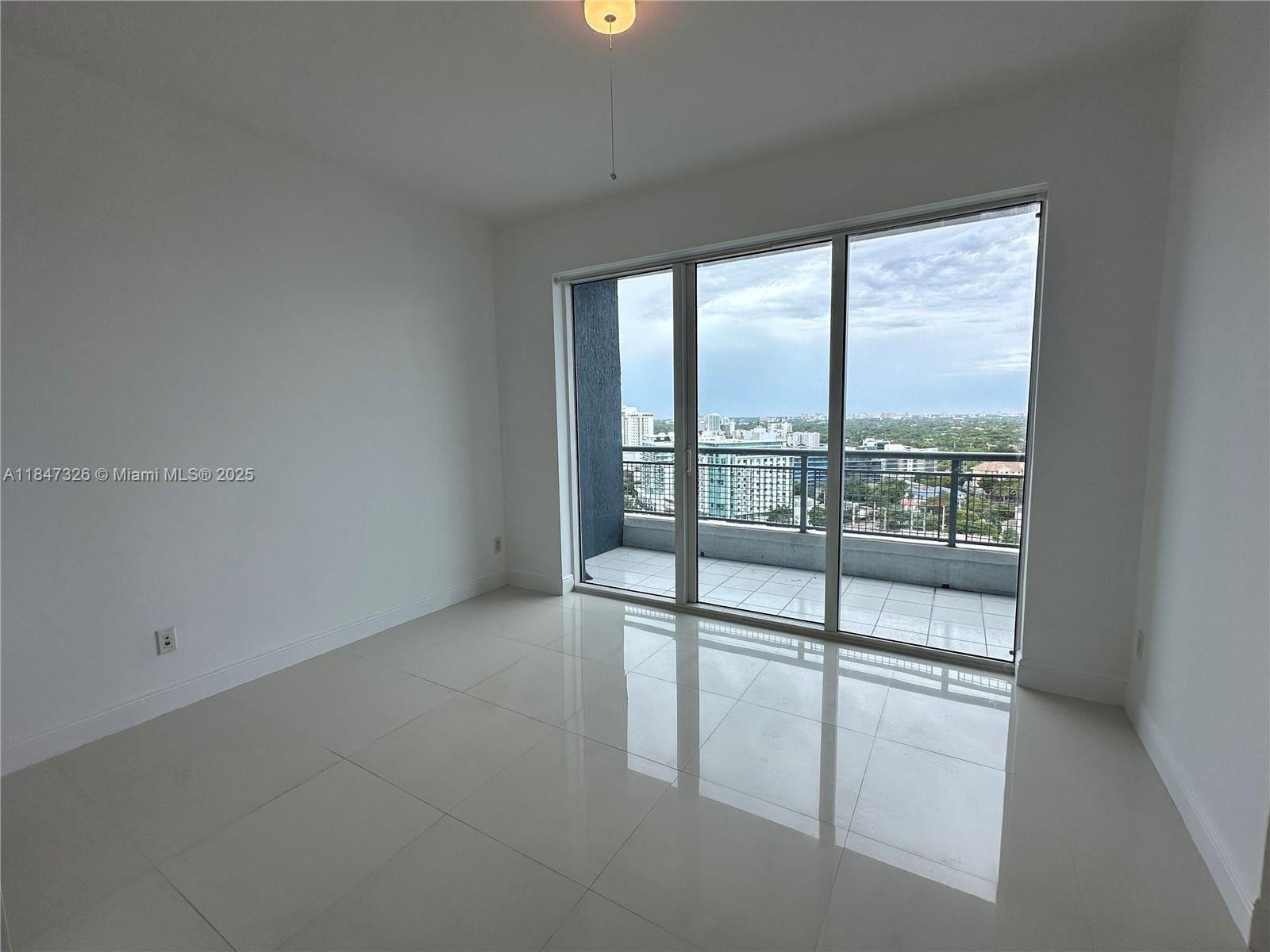 60 Southwest 13th Street, Unit 1605 Miami, FL 33130 - Photo 9 of 28 a view of an empty room with a window