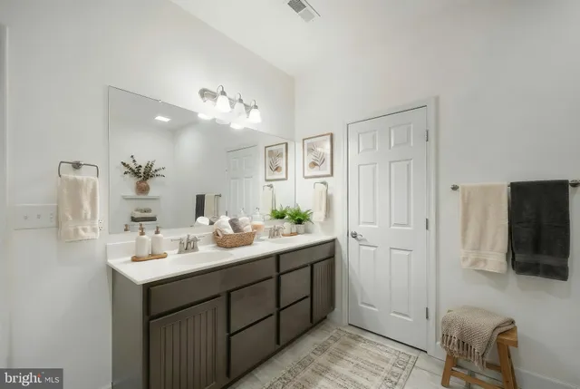 a bathroom with a double vanity sink and mirror