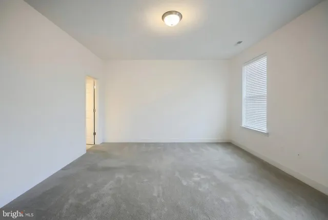 an empty room with a empty space and window