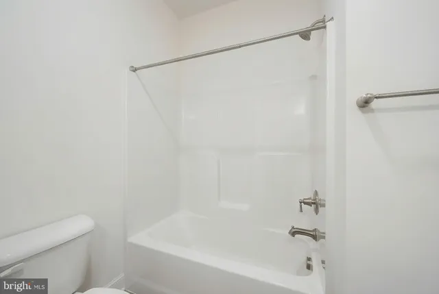 a bathroom with a shower and a toilet