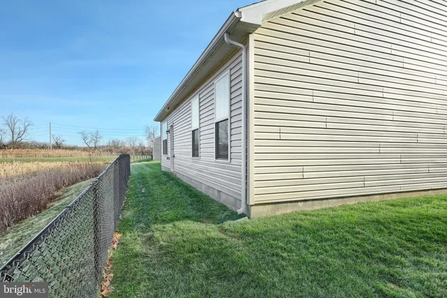 a view of park with wooden fence and trees