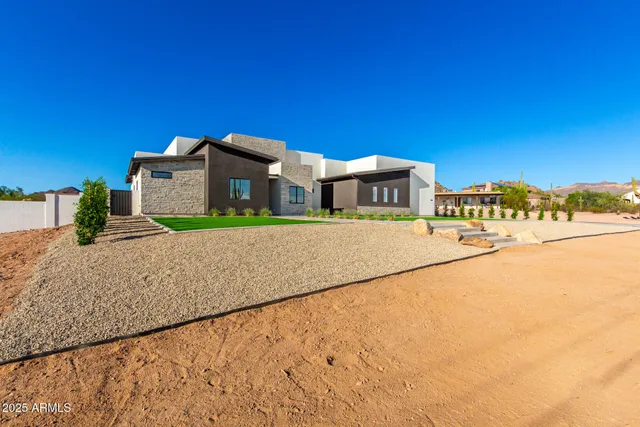 a kitchen with stainless steel appliances kitchen island granite countertop a refrigerator and a sink