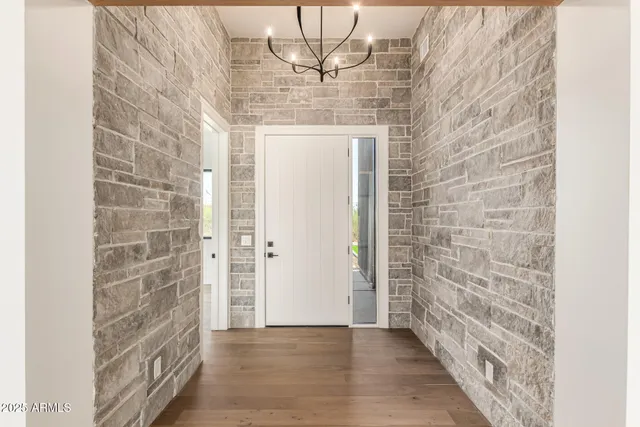 a kitchen with stainless steel appliances granite countertop a sink a stove and a wooden floors