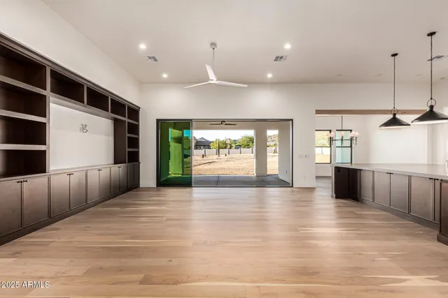 a view of a room with wooden floor and window