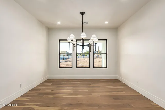 a view of a room with wooden floor and a window