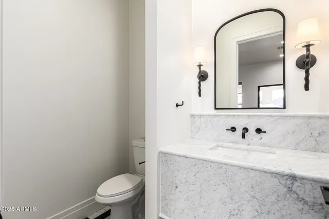 a bathroom with a toilet a sink and shower