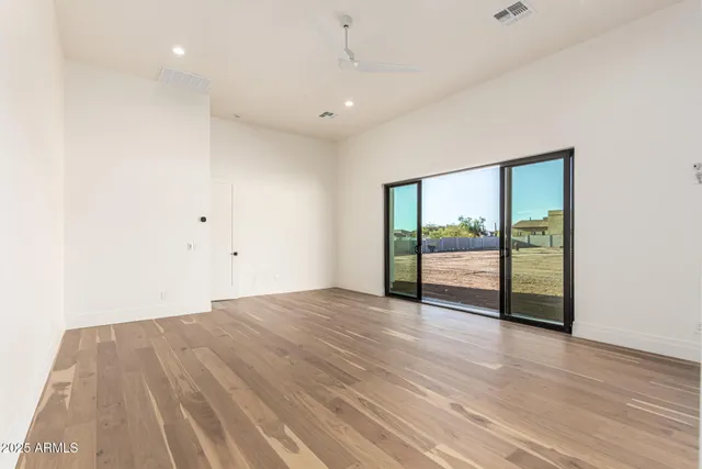 a bathroom with a bathtub shower sink mirror and toilet
