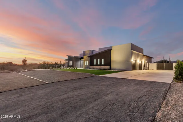 a front view of a house with a garden and yard