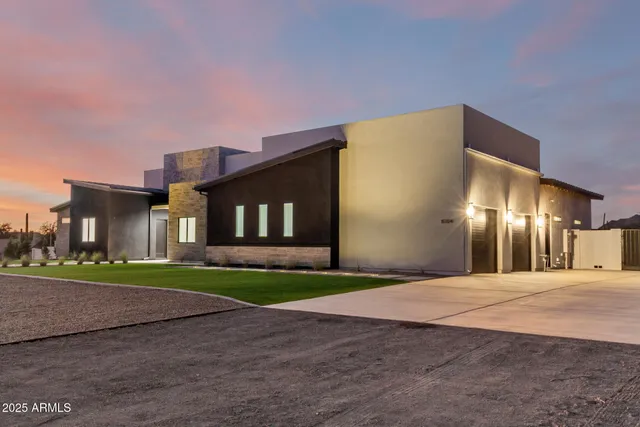 a view of a house with a yard and a garage