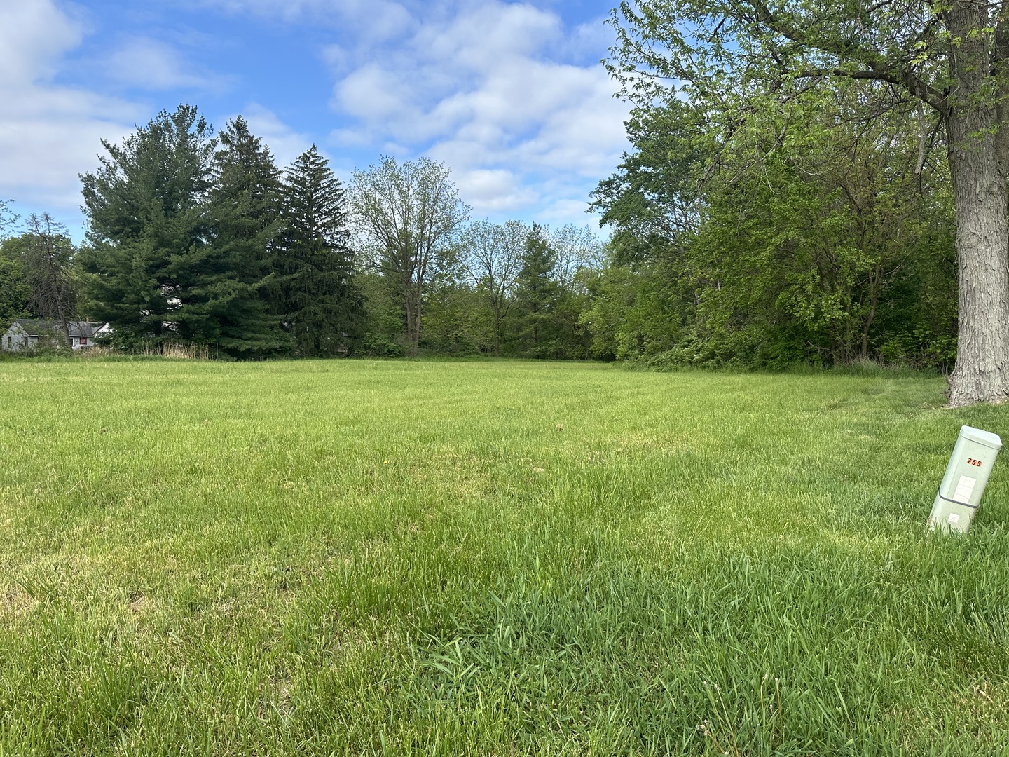a view of field with trees in the background