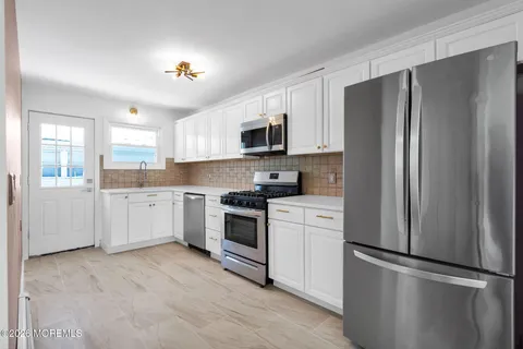 a kitchen with a refrigerator stove and sink