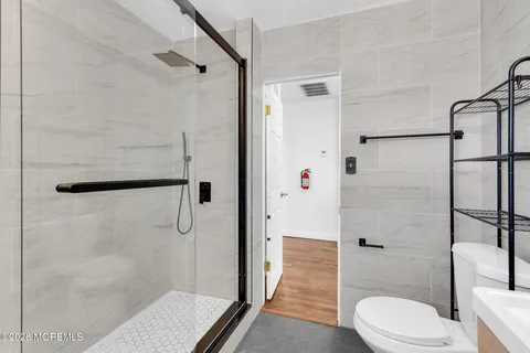 a bathroom with a shower and a toilet