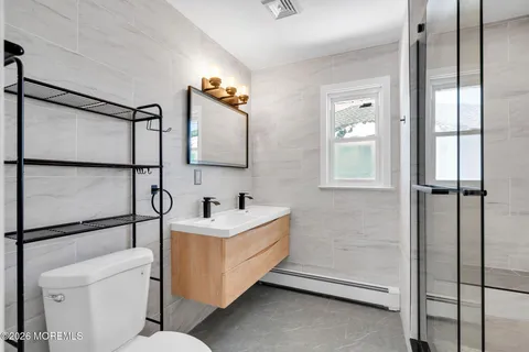 a bathroom with a sink toilet and mirror