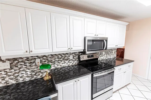 a kitchen with stainless steel appliances a stove a microwave and cabinets