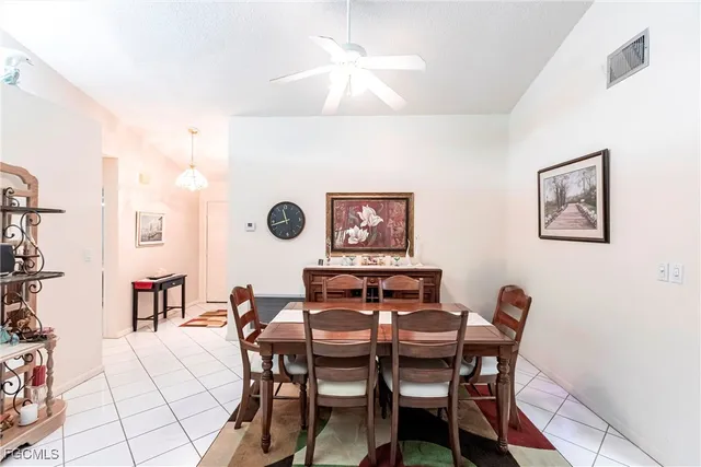 a view of a dining room with furniture and a chandelier