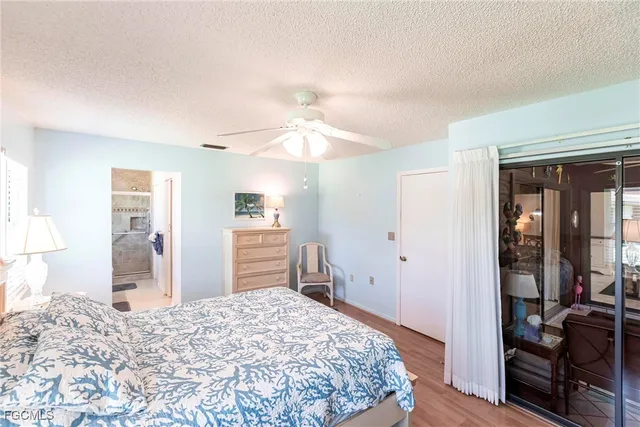 a bedroom with a bed and a dresser with mirror