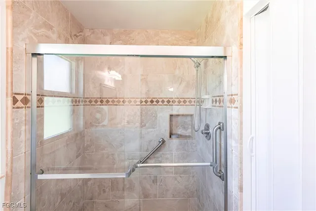 a bathroom with a glass shower door
