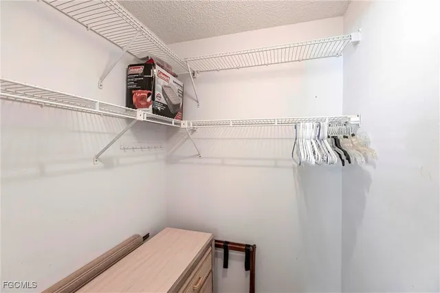 a view of storage and utility room with racks on the wall