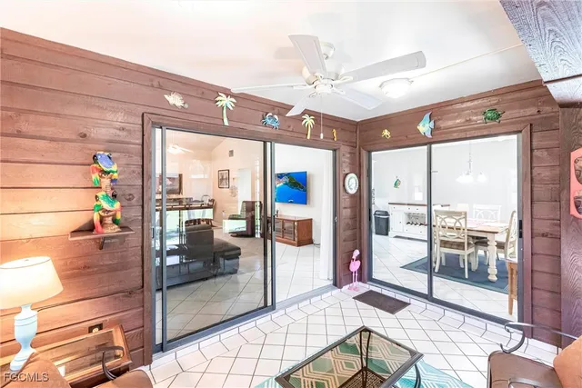 a view of a hallway with a glass door and furniture