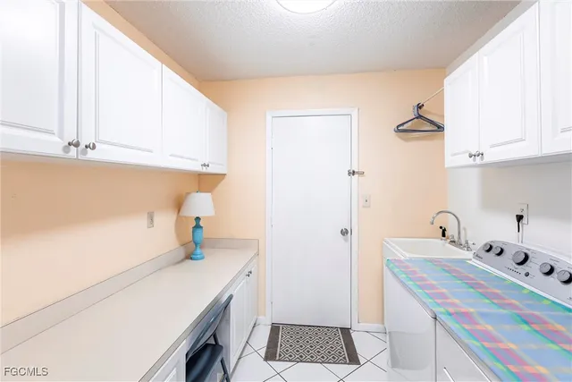 a room with a sink and cabinets