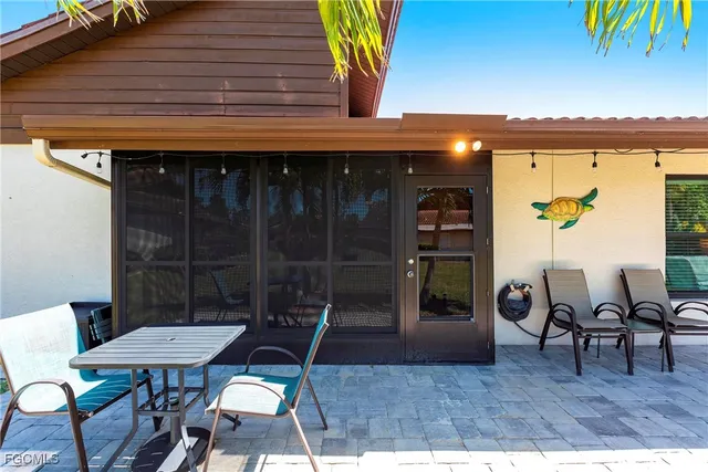 a view of a chairs and table in patio