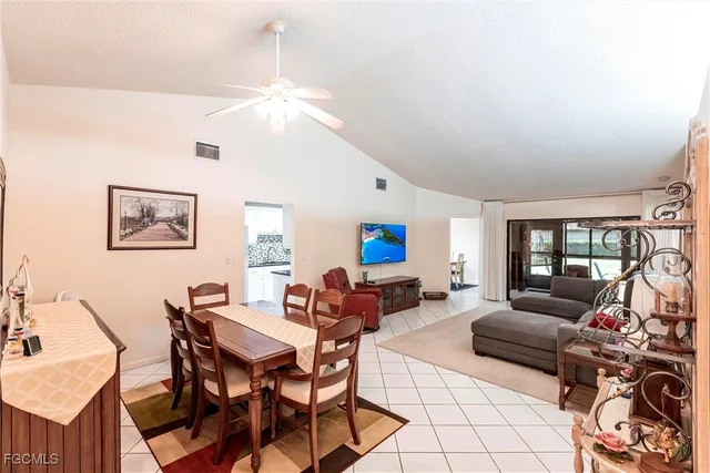 a living room with furniture a fireplace and a chandelier