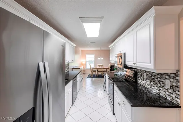 a kitchen with refrigerator and window