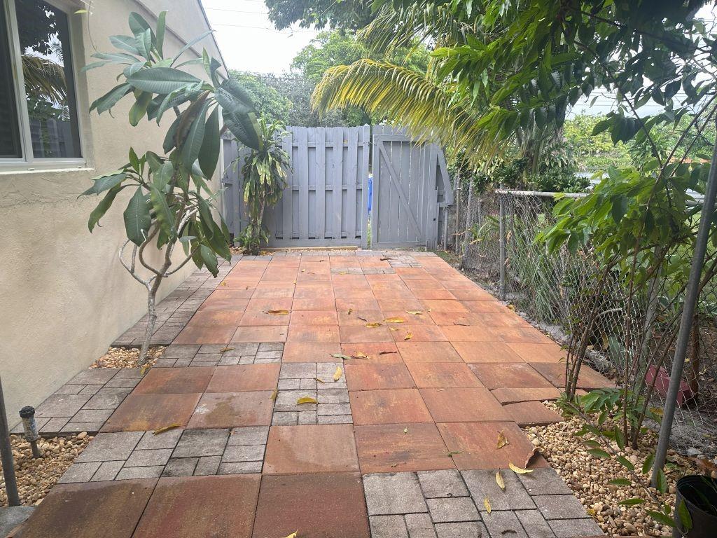 a pathway of a house with a yard