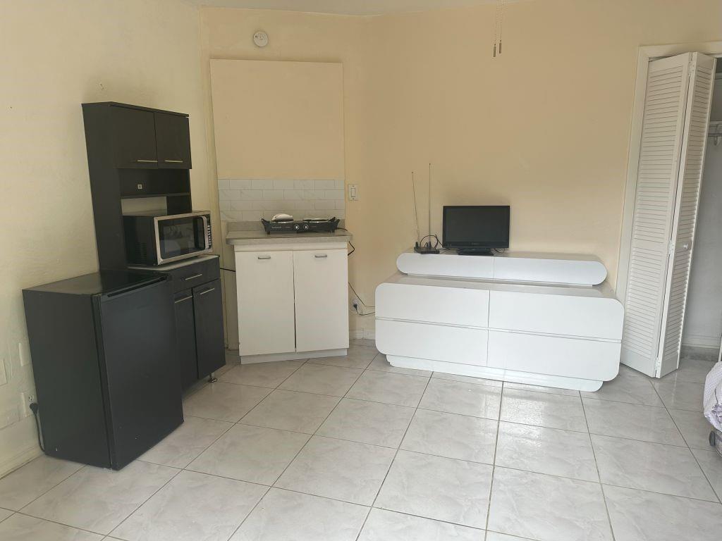 4610 Peters Road Plantation, FL 33317 - Photo 3 of 8 a kitchen with a cabinets and appliances