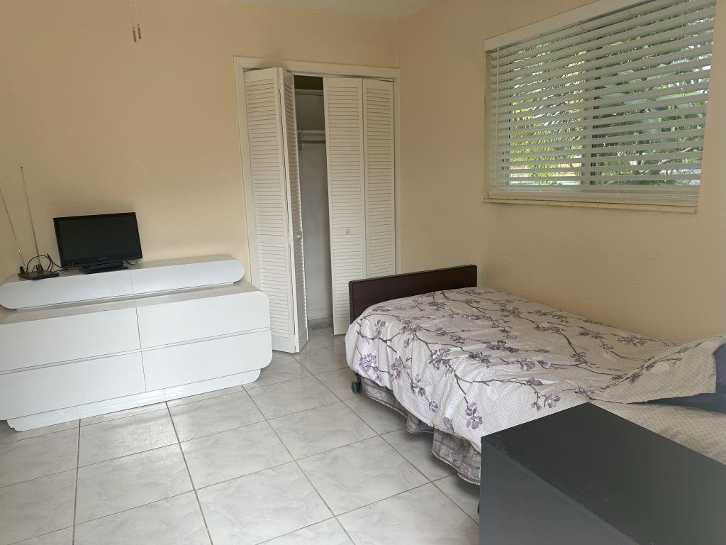 4610 Peters Road Plantation, FL 33317 - Photo 4 of 8 a bedroom with a bed and a cabinets