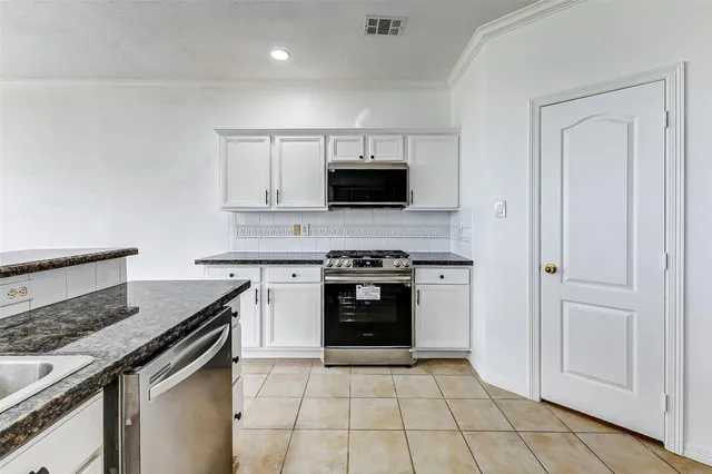 a kitchen with a stove and a microwave