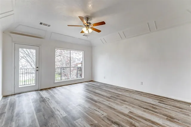 wooden floor in an empty room with a window