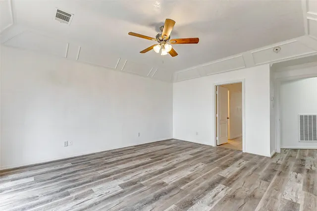 a view of a room with a ceiling fan