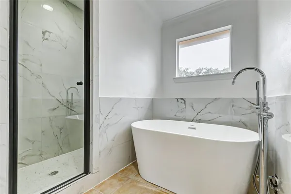 a white bath tub sitting next to a bathroom sink