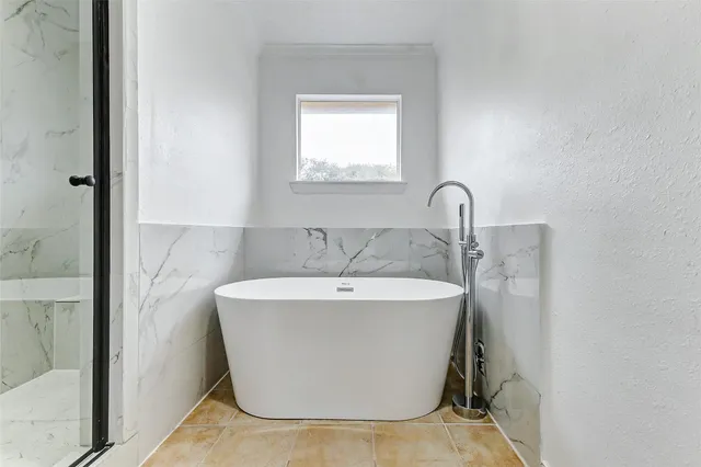 a white bath tub sitting in a bathroom