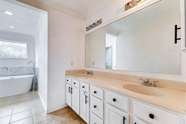 a bathroom with a tub sink and mirror