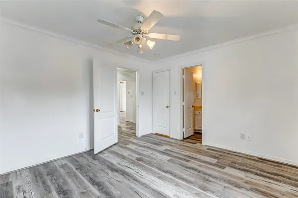 a view of a livingroom with a hardwood floor and a ceiling fan