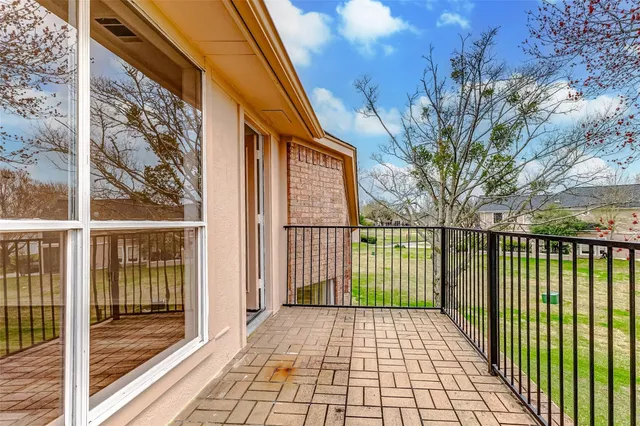 a view of a brick house with a large window