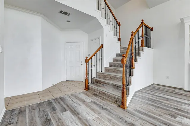 a view of entryway and hall with wooden floor