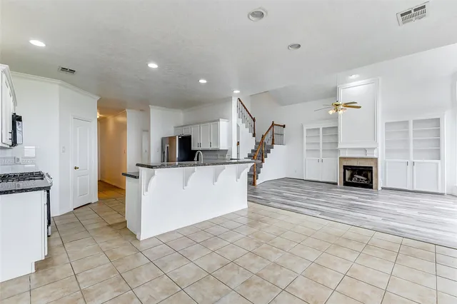 a large white kitchen with cabinets