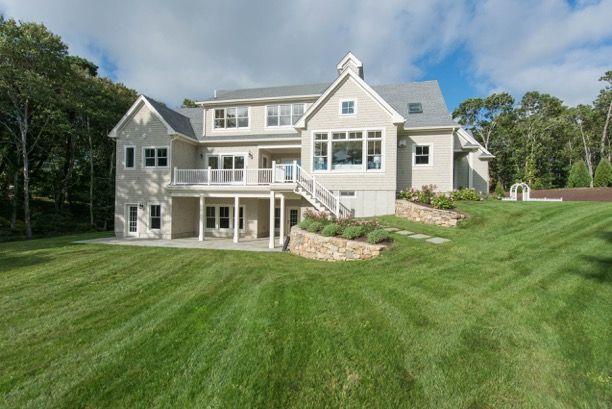 135 Ice Valley Road Osterville, MA 02655 - Photo 7 of 35 a front view of a house with a yard table and chairs