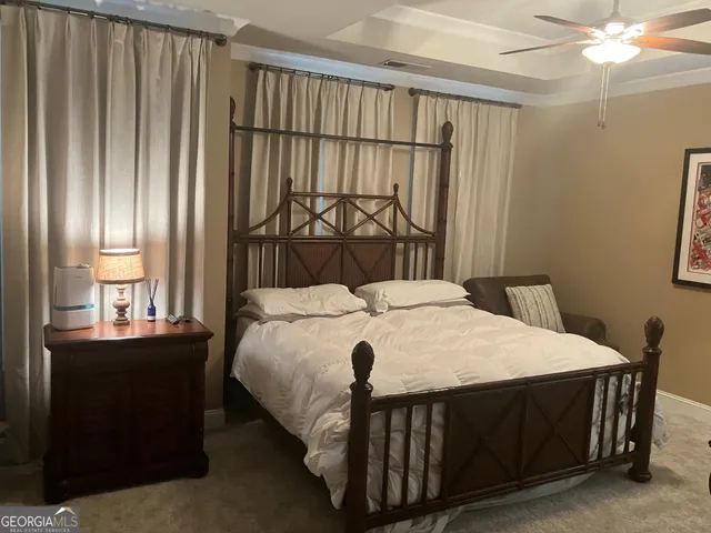 a bed sitting in a bedroom next to a window